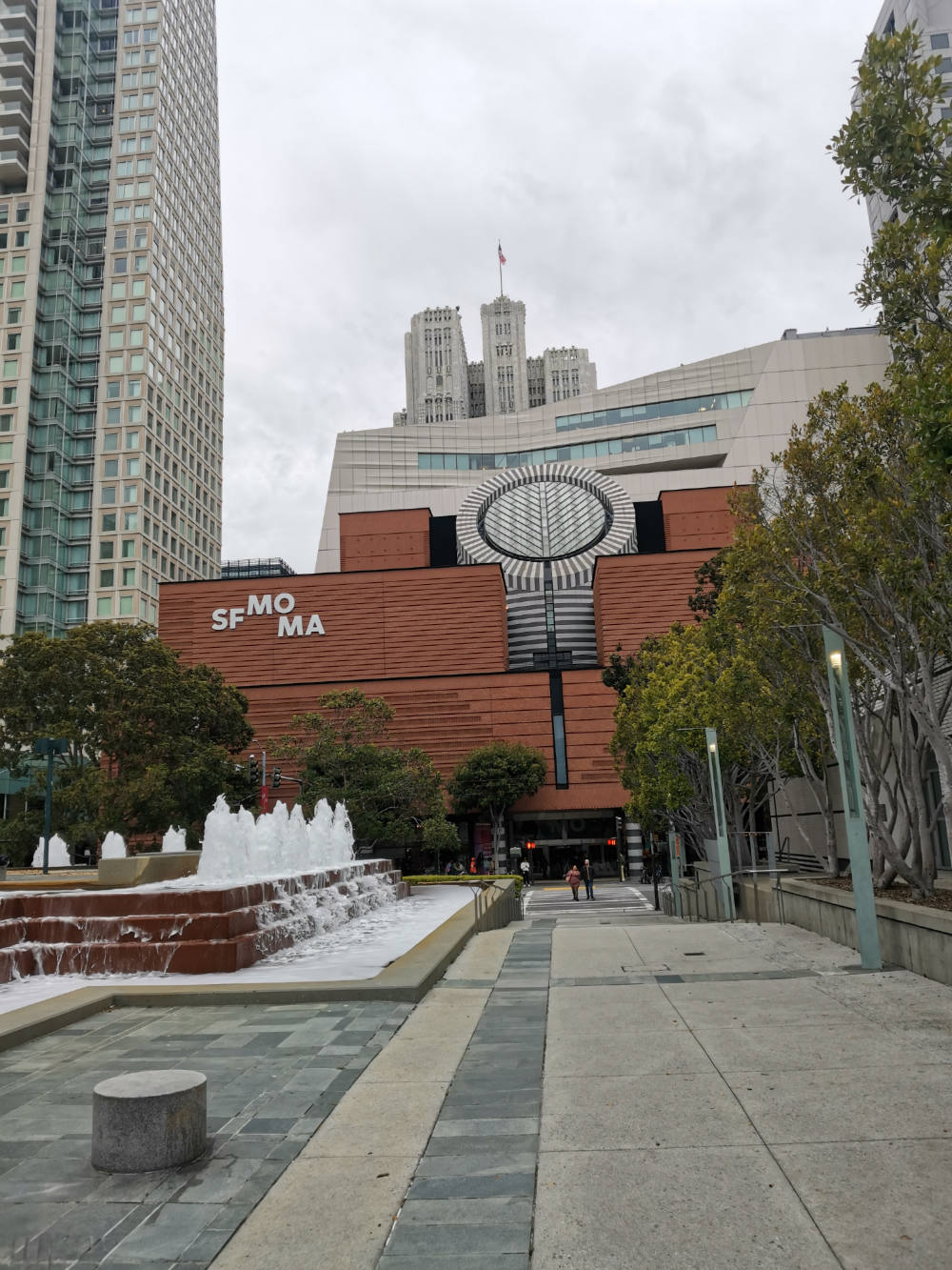 Image: View of the San Francisco Museum of Modern Art, surrounding buildings and fountain.