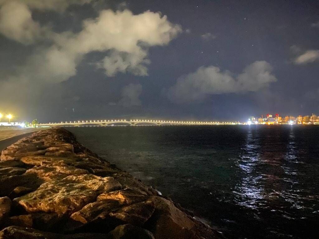 Bridge and the floating lights of Male' City from Velaanaa International Airport. Photo: Thoiba Saeedh, 2021. 