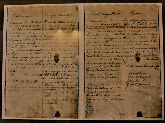 Article Image: A copy of the bilingual treaty of annexation signed on 9 September 1888, between the Council of Chiefs and the Chilean captain Policarpo Toro. This copy is exhibited in the reception hall of the Municipality of Rapa Nui. Photo: Diego Muñoz, November 2018, Hanga Roa, Rapa Nui.